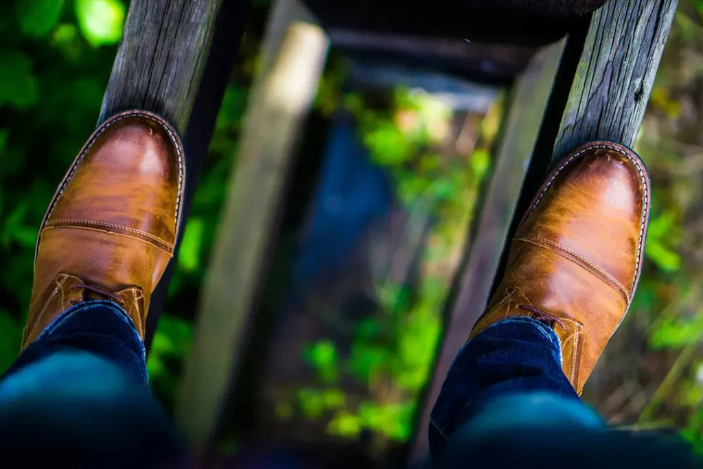 Man facing his fears by standing on a tall ledge.